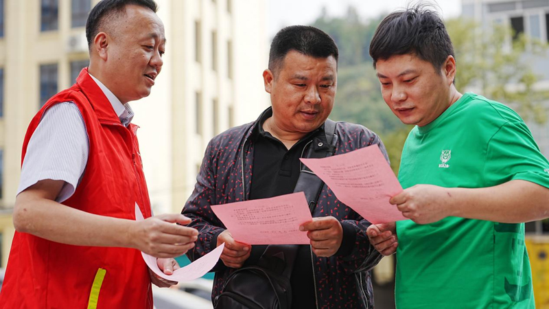 志愿者進社區分發《閑置教玩具捐贈倡議書》。李卡/攝