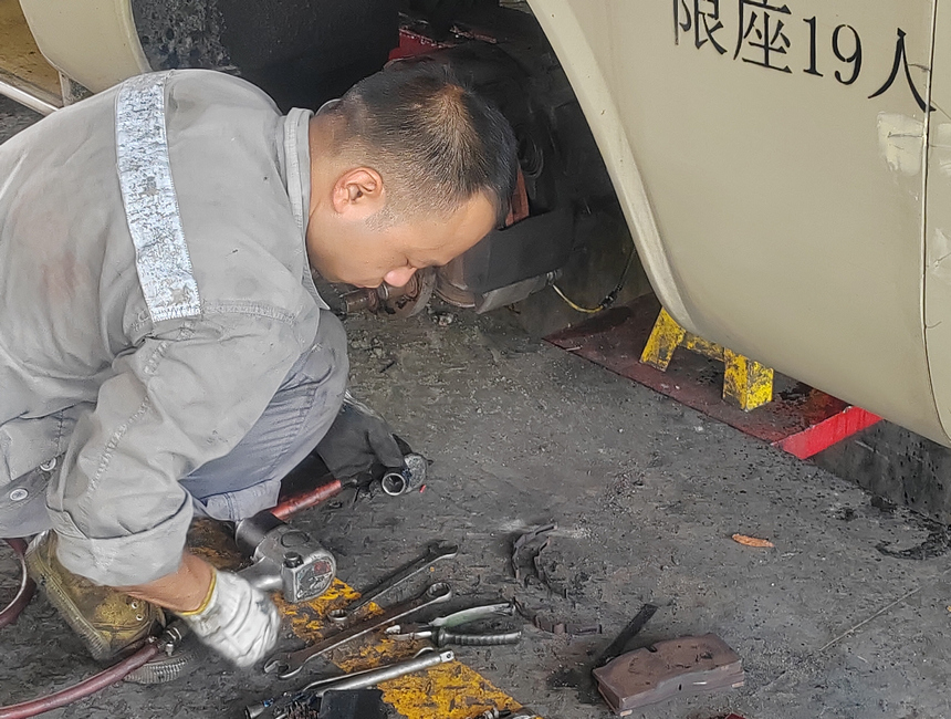 公交車維修工正在選取工具更換軸承。胡靜攝