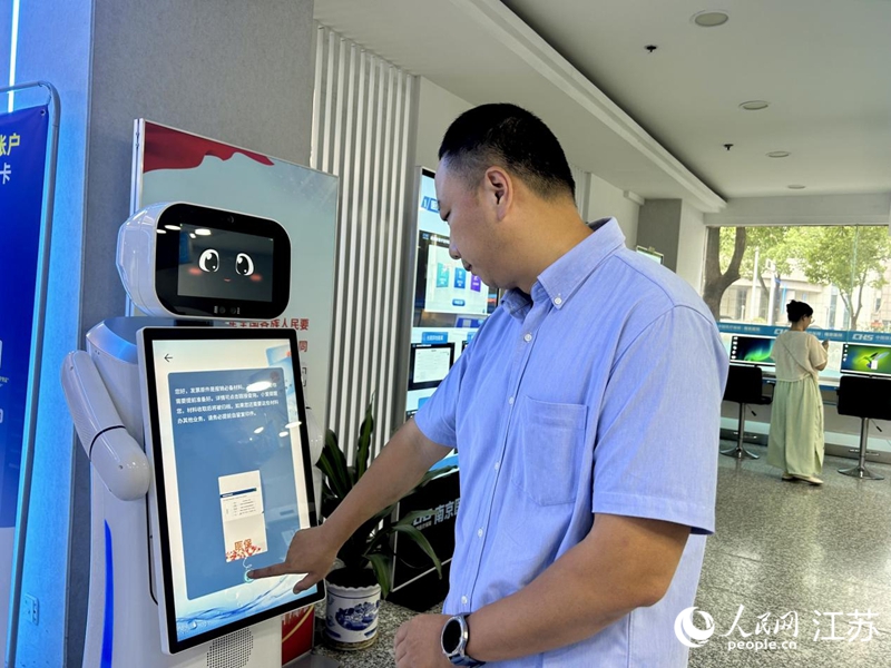 工作人員正在測試智慧醫保服務機器人。人民網 王丹丹攝
